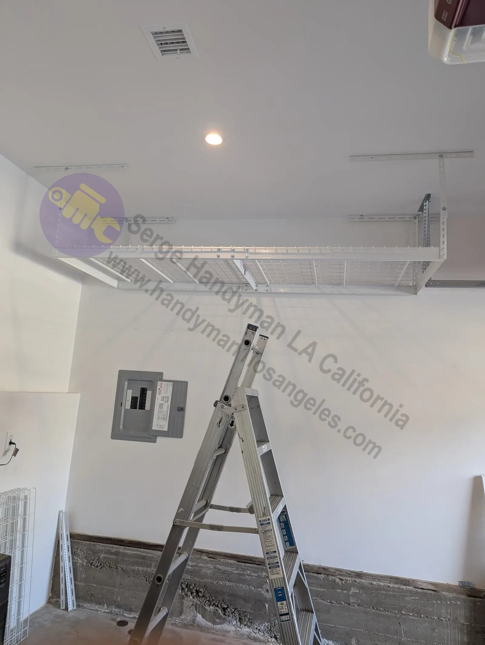 Professional installation of overhead garage storage racks mounted to ceiling joists in Los Angeles garage.
