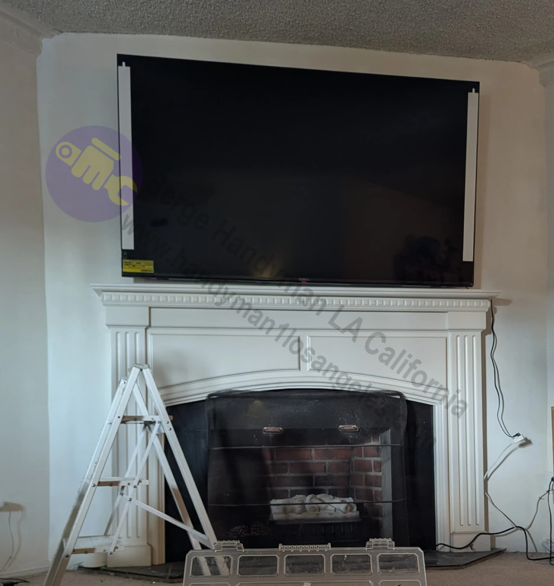 85-inch Flat screen TV mounted above fireplace in Los Angeles CA